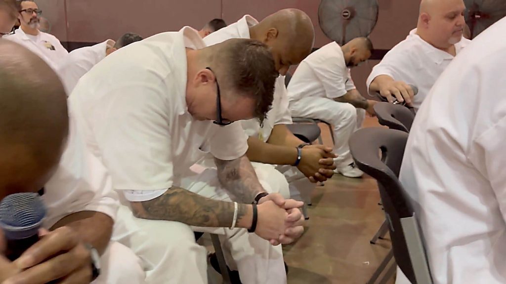 Men participate in a Worship Service at Polunski Unit